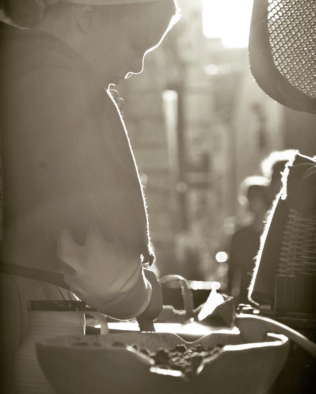 A musician in profile, silhouetted by stage light